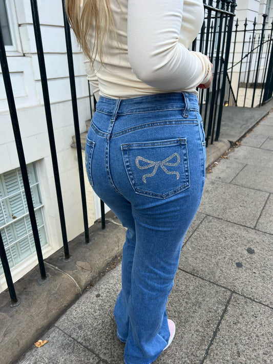 Mid rise straight leg jeans with diamonte bow back pocket detailing