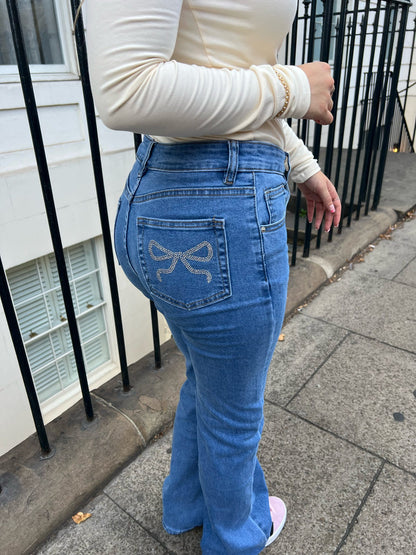 Mid rise straight leg jeans with diamonte bow back pocket detailing